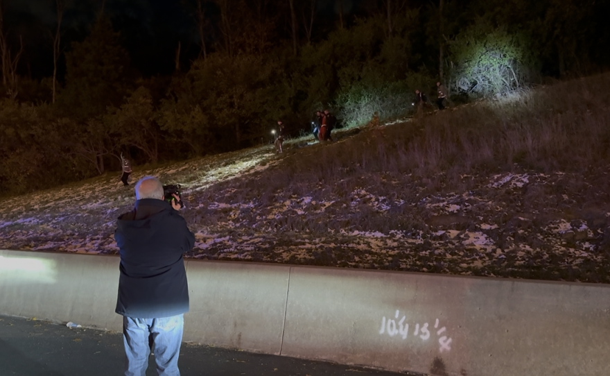 Ohio Public Media Statehouse News Bureau Multiple Media Journalist Dan Konik shoots video of a suspect being taken into custody by a multi-agency task force in Cincinnati on October 30, 2025
