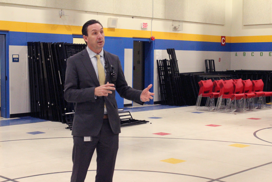 Assistant City Manager Troy Anderson gives a tour of the men's quarters of the winter shelter.