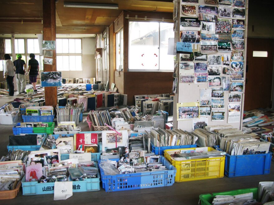 The tsunami  washed away countless homes, but thousands of photos were recovered amid the mud and wreckage in Yamada. These photos are waiting for their owners to reclaim  them.