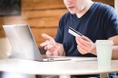 Credit card problem. Online bank not working or bad internet connection. Confused and surprised man holding bank card and spreading hands. Financial difficulties or no money. Forgot password.