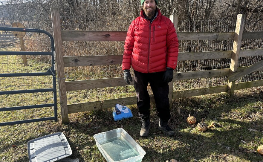 Animal Care and Facilities Manager Ryan Wenck shows one of Indraloka Animal Sanctuary's chlorhexidine baths they use to sanitize shoes before people enter the sanctuary.