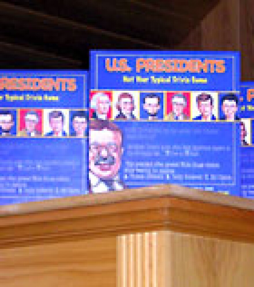 Boxes of Neil's board game, U.S. Presidents: Not Your Typical Trivia Game, in the McCalmont's house.