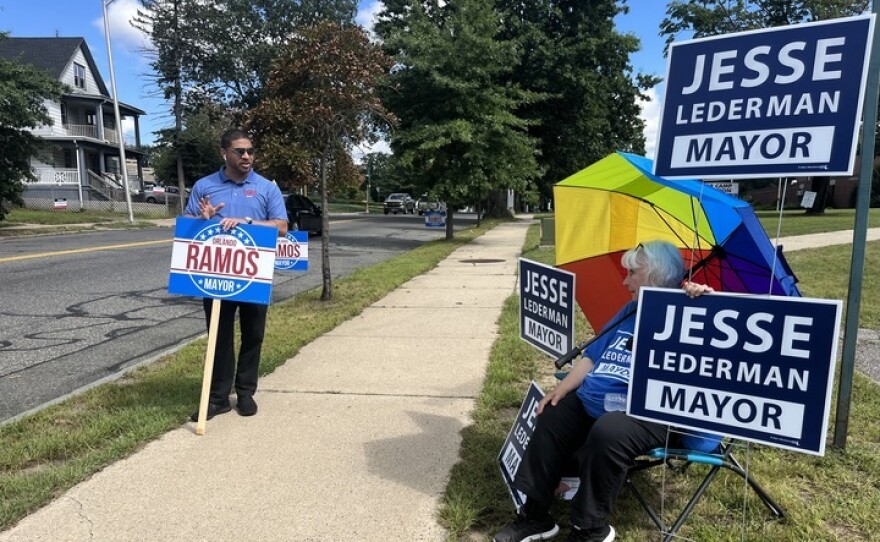 Springfield, Massachusetts, mayoral candidate and state Rep. Orlando Ramos holds a sign outside the Boys and Girls Club polling location on Sept. 12, 2023.