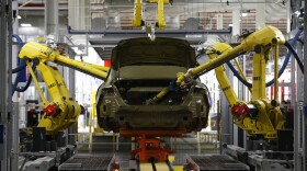 In this March 14, 2014 file photo, automated robots build a 2015 Chrysler 200 at the Sterling Heights Assembly Plant in Sterling Heights, Mich. (AP Photo/Paul Sancya, File)