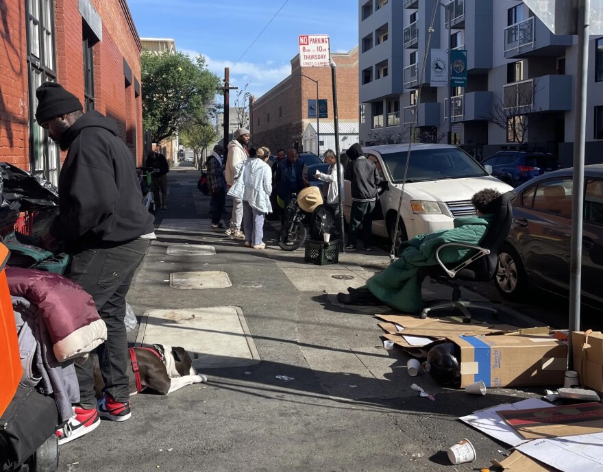 A crowd gathers around Nurse Albert in the Mission District on March 23, 2026