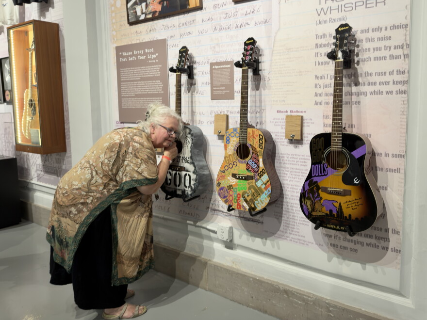 A museum guest listens to a guitar specially tuned for the Goo Goo Dolls' hit "Name" during an exclusive member-only event for the exhibit "Long Way Home: 40 Years of the Goo Goo Dolls" at the Buffalo History Museum on September 16, 2026.
