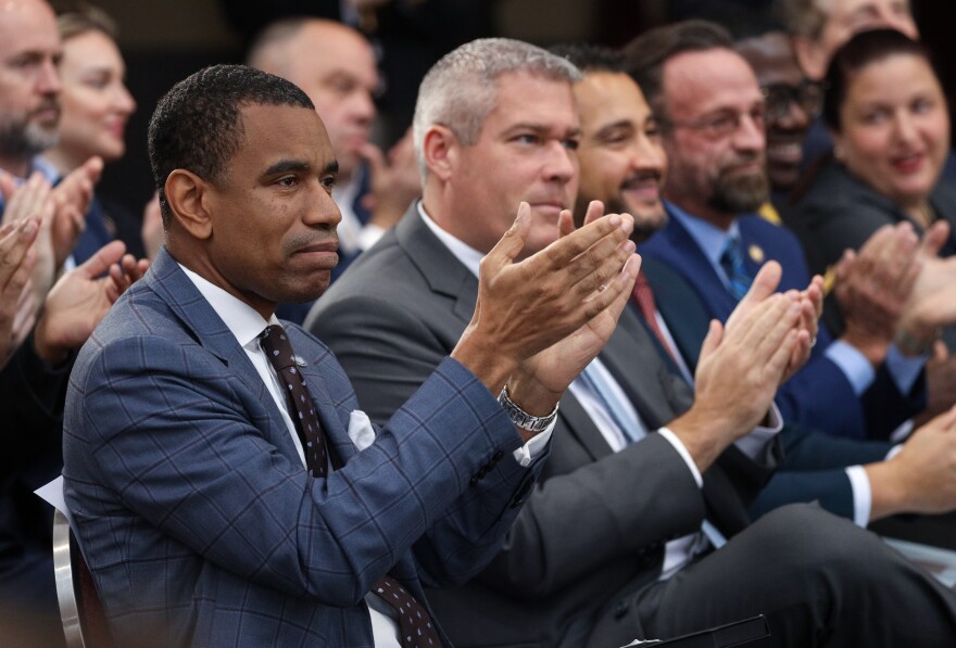 Rochester mayor, Malik Evans, claps during an announcement by Gov. Kathy Hochul that the state awarded 10 million dollars in redevelopment funding for 5 projects on or around the Main and Clinton corner in downtown Rochester, Monday at a news conference.