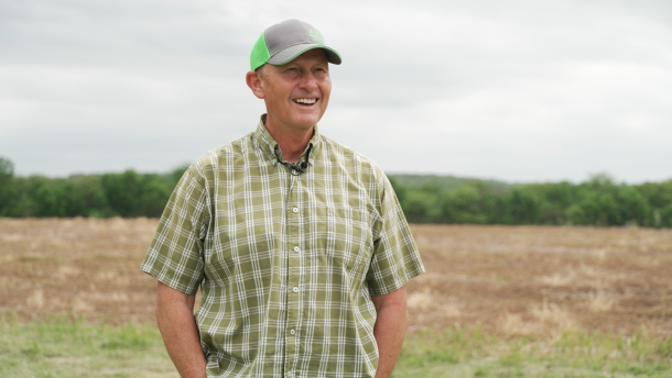 John Samek stands next to a crop field on his farm in Bolivar, Mo. in May 2026.