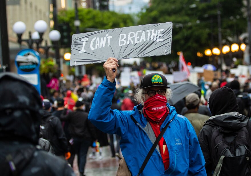 A Seattle protester holds up a sign that says "I can't breathe" — the last words caught on video before George Floyd was killed by a police officer in Minneapolis. The officer faces murder charges. 