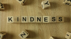 Kindness word from wooden blocks on desk