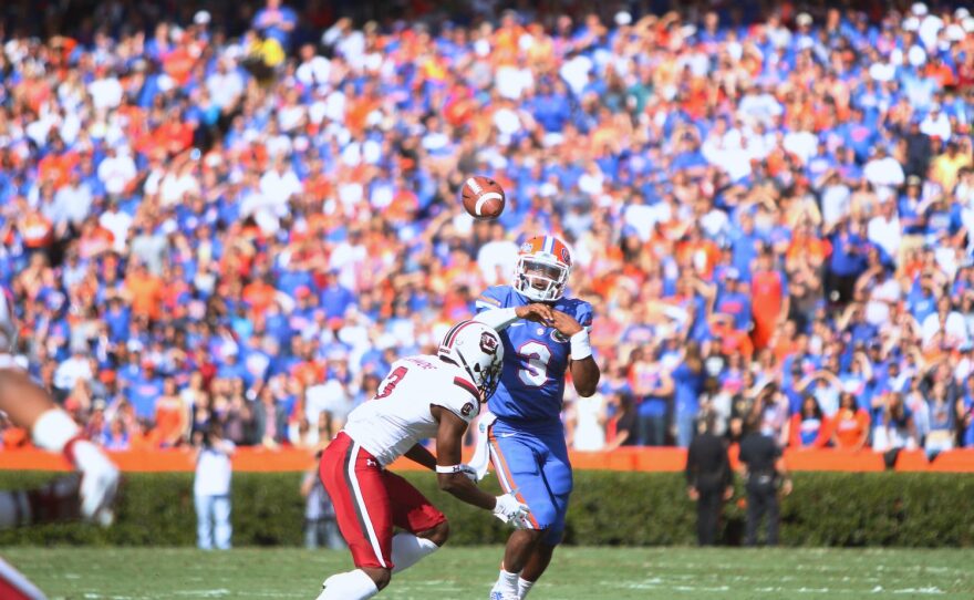Florida quarter back Treon Harris rolls out to his left, looking for a receiver downfield.