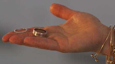 FILE - A marriage official offers a couple their rings during their wedding at the Empire State Building in New York.