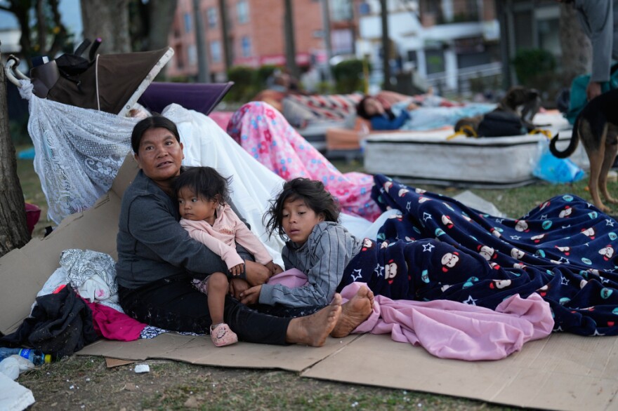 People camp out in a park two days after an earthquake damaged their homes in Pereira, Colombia.