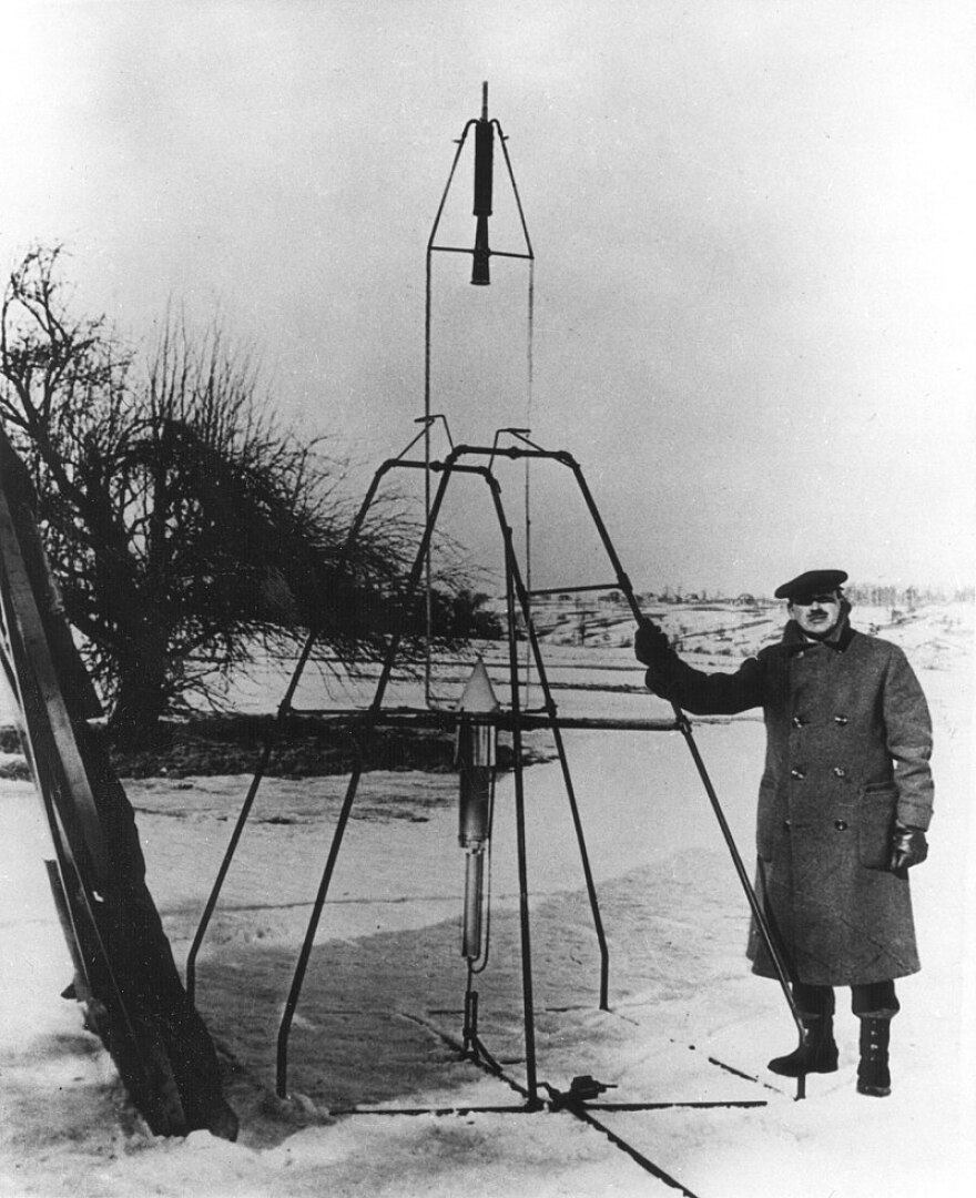 Dr. Robert H. Goddard and a liquid oxygen-gasoline rocket at Auburn, Massachusetts.