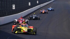 Delvin Defrancesco leads a group of cars into Turn 1 during testing at Indianapolis Motor Speedway, Thursday, April 21, 2022, in Indianapolis.