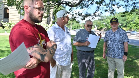 Tyler Meyers, Joe Granteed, Walter Griffith and Thomas Potsko prepare to hold a press conference.
