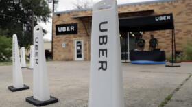 Workers set up in a tent to welcome drivers back to the Uber offices in Austin, Texas, in May. Uber and Lyft, the ride-hailing company giants who left Texas' capital city in a huff a year ago over local fingerprint requirements for drivers, are set to return after state lawmakers stepped in. (Eric Gay/AP)