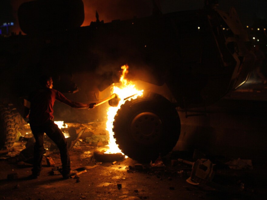 <p>A Coptic Egyptian demonstrator sets on fire an army vehicle during clashes with Egyptian army soldiers following a demonstration in Cairo on Sunday.</p>