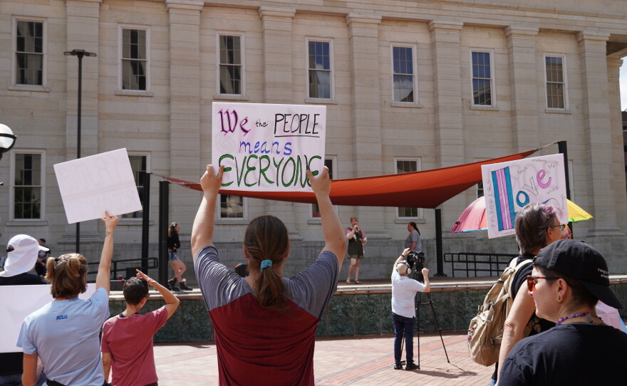 Rally supporters holding signs.
