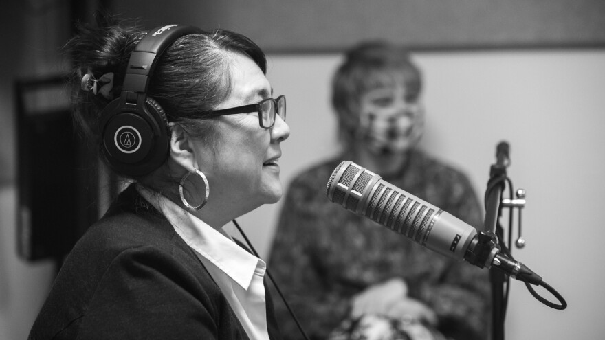 Sueann reacts to Kwabi during their interview. Producer Ashley Beard sits in the background.