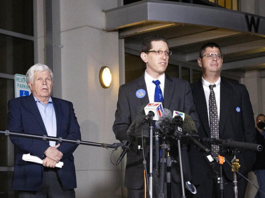 Charlie Cytron-Walker, rabbi of Congregation Beth Israel, center, makes a statement to the media after a service at White's Chapel United Methodist Church in Southlake, Texas, Monday, Jan. 17, 2022.