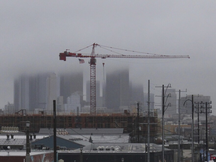 Storm clouds cloak downtown high rises in Los Angeles, Saturday, Feb. 25, 2023, as a major winter storm sweeps through California. The storm piled snow high in the mountains and dropped heavy rain. The National Weather Service said it was "one of the strongest storms ever to hit southwest California."