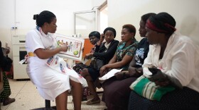 A nurse uses a diagram of the female reproductive system to explain the do-it-yourself careHPV test at the Uganda Cancer Institute in Kampala.