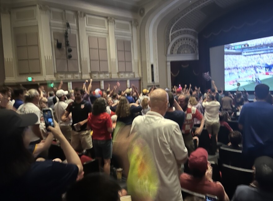 Team USA fans erupted in applause at the Kentucky Theatre after USMNT scored its first, and only goal against Belgium Monday night.
