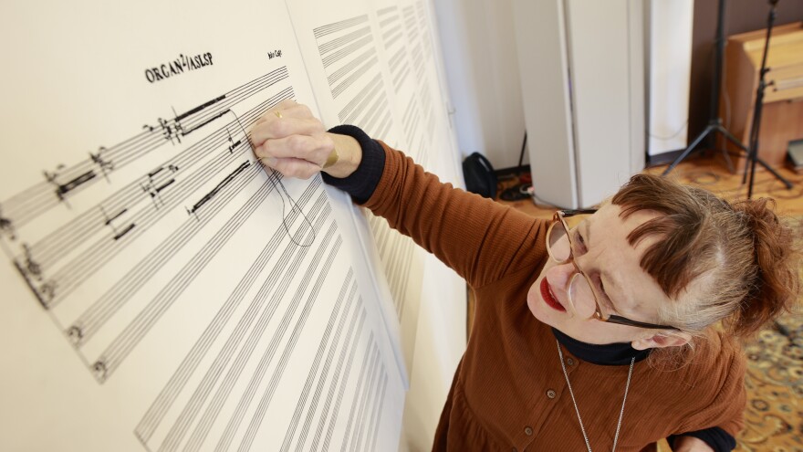 View of an embroidered sheet of music from the piece <em>Organ2/ASLSP</em> by John Cage. Artist Sabine Groschup expands the embroidery with each change of sound. After two years, the sound of the slowest piece of music in the world, has changed for the 16th time. This means that the six-sound piece that has been played in the Burchardi Church since February 2022 has become a seven-sound piece.