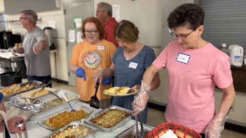 Volunteers from Calvary Episcopal Church serve food at the Saturday Morning Cafe, now hosted at Room at the Inn, on July 5, 2025 in Columbia, Mo.