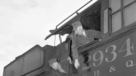 Engineer F.A. Steib sits in the cab of a Burlington Locomotive in Chicago, May 25, 1946, as L.H. Hager gets orders from Tom Mensdorf (on ground) after men signed in with the railroad roundhouse foreman for duty following termination of the strike. (AP Photo/Harry L. Hall)