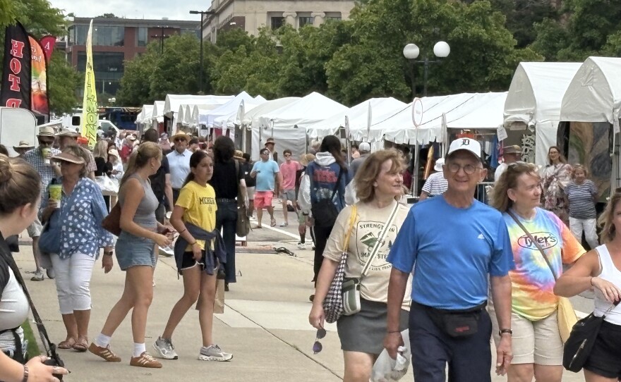 Residents walk through the 2025 Ann Arbor Art Fair.