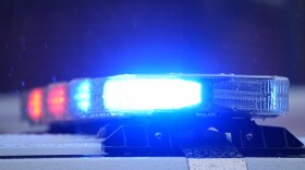 Close up police lights can be seen atop a white car 