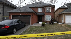 A police oficer walks around Alek Minassian's house in Richmond Hill, Ontario, on April 24, 2018. (Lars Hagberg/AFP/Getty Images)