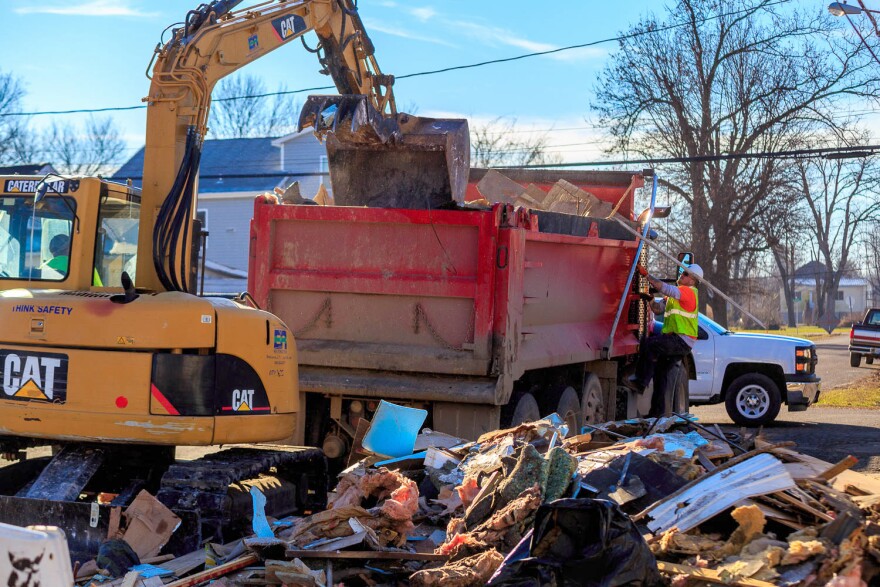 Crews contracted by the Environmental Protection Agency pick up flood debris in Pacific, Mo. in January 2016.