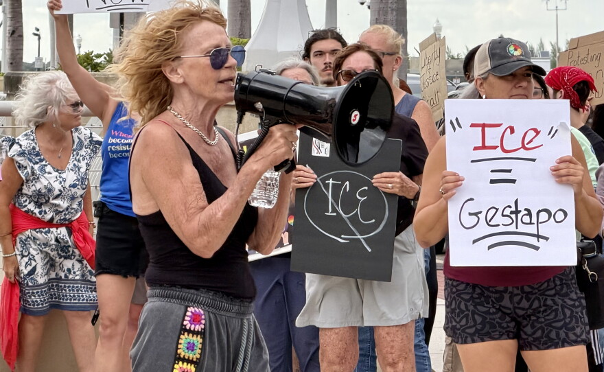 Legal observer June Sanson speaks to a crowd of approximately 150 people during the Ice Out Now protest in front of the Luminary Hotel in downtown Fort Myers in a effort to shine light on how ICE agents are staying in hotels to preform ICE activities throughout the community.