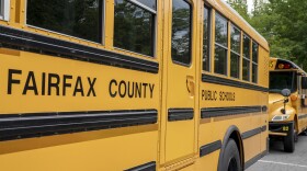 Fairfax County Public School buses sit idle at a middle school in Falls Church, Va., July 20, 2020.