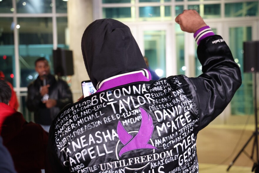 A protestor at a demonstration outside the Dallas Police Department wears a jacket with the names of Black people slain by police over the years. The demonstration was in response to the release of a video depicting Tyre Nichols being beaten by Memphis Police.