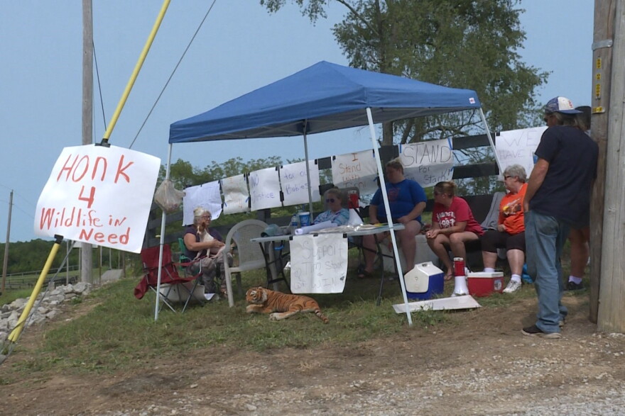 Several local residents sit along Wildlife In Nature’s property to support Tim Stark and his animals.