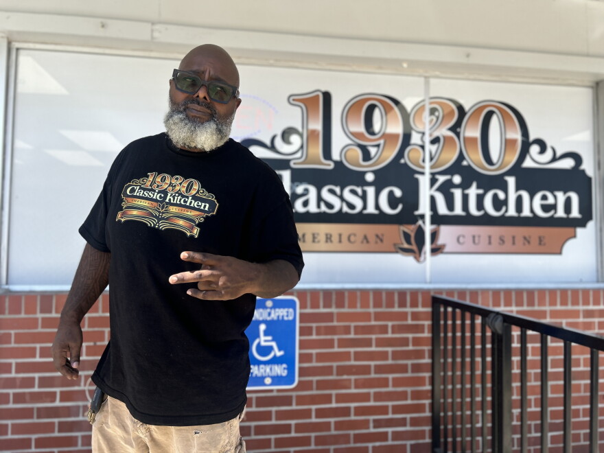Free Davis is standing in front of his restaurant, 1930 Classic Kitchen, after serving the lunch crowd.