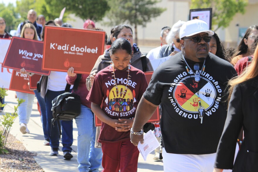 Tize W. Clark, right and his son, Zion Clark, participate in a walk to honor Native American and Indigenous relatives who have gone missing or have been killed as Missing and Murdered Indigenous Persons Awareness Day is marked in Albuquerque, New Mexico, on Monday, May 5, 2025. (AP Photo/Susan Montoya Bryan)