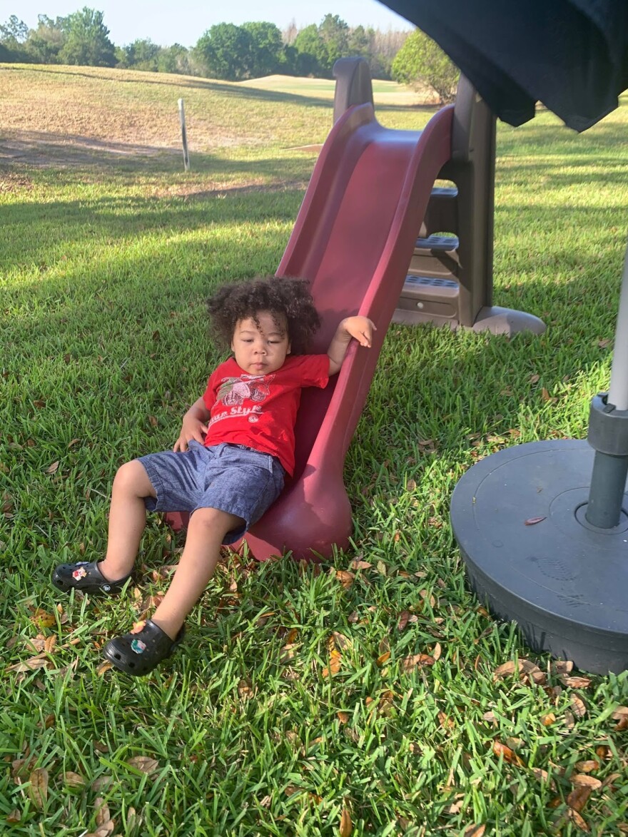 One of Kimberly Asante's children plays on a slide she got on her local Buy Nothing group. She finds that the community that she gets from the group is worth more than any money she could make selling instead of giving away her items.