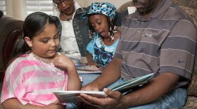 Eight-year-old Erica and seven-year-old Alicia read their books with mom, Candice, and dad, Randy Reese. This Brighton family lost their firstborn, Nevaeh, who was born at just over a pound.