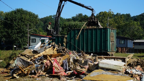 A claw operator scoops up debris from homes demolished following Hurricane Helene in Old Fort, N.C., on Thursday, Sept. 11, 2025.