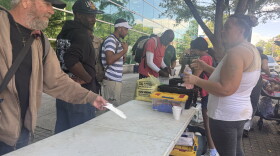 People line up for meals and beverages outside Richland Library Main in Columbia.