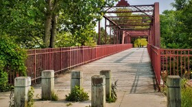 A red double-span steel bridge on a biking and pedestrian trail near South Bend. (Skip Barnett/WVPE Photo of The Week) 