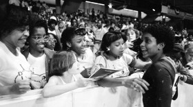 FILE - In this June 5, 1983, file photo, Dianne Durham, right, of Gary, Ind., gives autographs after winning the women's title at the McDonald's U.S.A. Gymnastic Championships at the University of Illinois in Chicago. Durham, the first Black woman to win a USA Gymnastics national championship, died on Thursday, Feb. 4, 2021, She was 52.