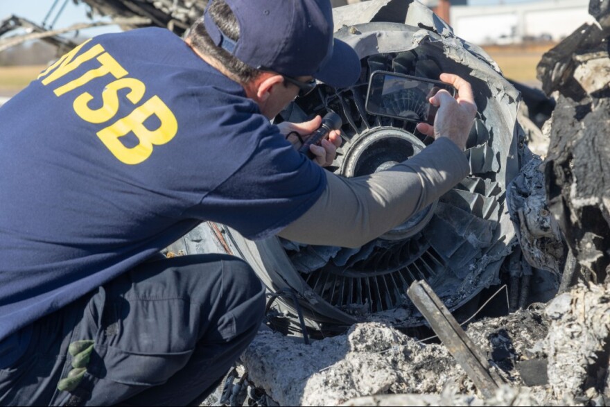 Man photographing wreckage