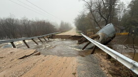 Storm damage to Johnson Road in Kaleva after rain-swollen Bear Creek twisted massive culverts and swept away the bridge. (Photo: Charlie Brooks / for the Northern Michigan Journalism Collaborative)