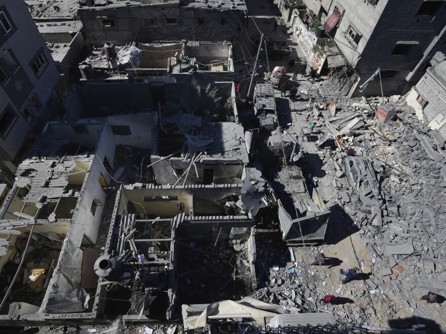 Palestinians inspect the rubble of destroyed buildings after an Israeli airstrike at the Nusseirat refugee camp, in central Gaza on Thursday.